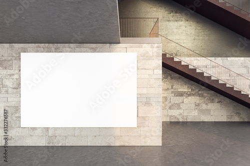 Stairs in office building with blank poster on brick wall.