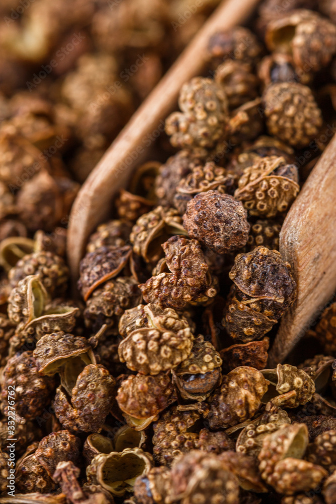 Obraz premium fragrant Sichuan pepper on white acrylic background