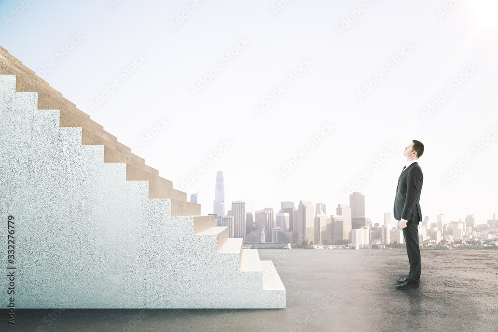 Businessman looking on abstract stairs