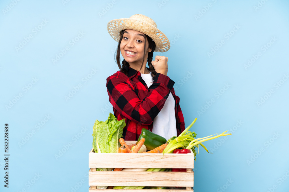 Young farmer Woman holding fresh vegetables in a wooden basket celebrating a victory
