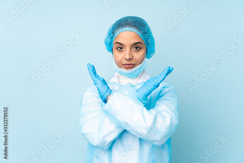 Young surgeon Indian woman in blue uniform making NO gesture © luismolinero