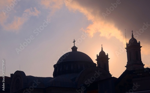 Church dome and christian crosses silhouetted against the afternoon sky in Istambul, Turkey.