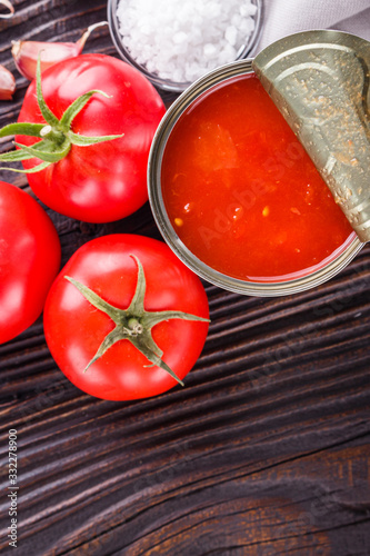 juicy canned tomatoes on wooden rustic background