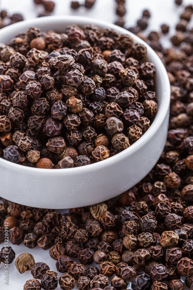 fragrant black pepper on white acrylic background