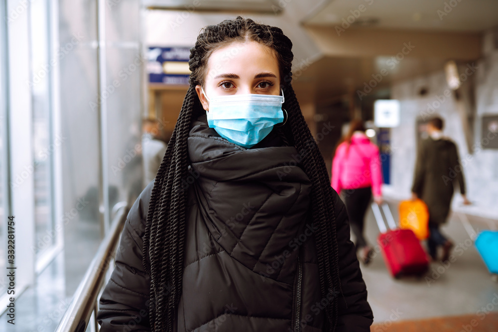 Girl in protective sterile medical mask on her face in quarantine city. Woman, wear face mask, protect from infection of virus, pandemic, outbreak and epidemic of disease in quarantine zone. Covid-19.