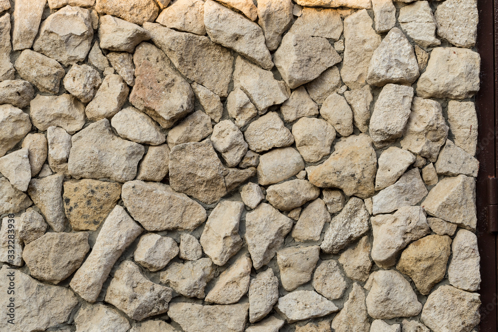 Background of limestone masonry. The surface is decorated with natural material. The wall is made of wild stone. Background of limestone masonry. The surface is decorated with natural material. The wall is made of wild stone.