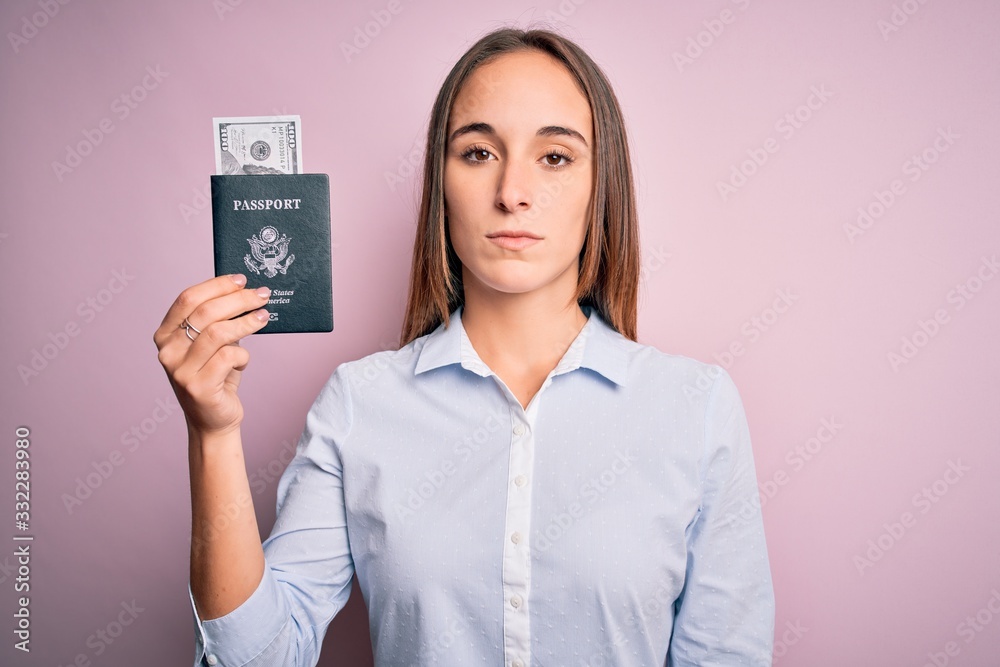 Tourist woman on vacation holding usa passport with dollars banknotes as a travel money with a confident expression on smart face thinking serious Tourist woman on vacation holding usa passport with dollars banknotes as a travel money with a confident expression on smart face thinking serious