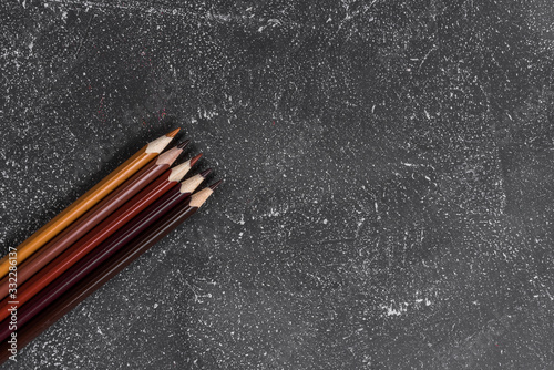 Brown pencils on a black stone table