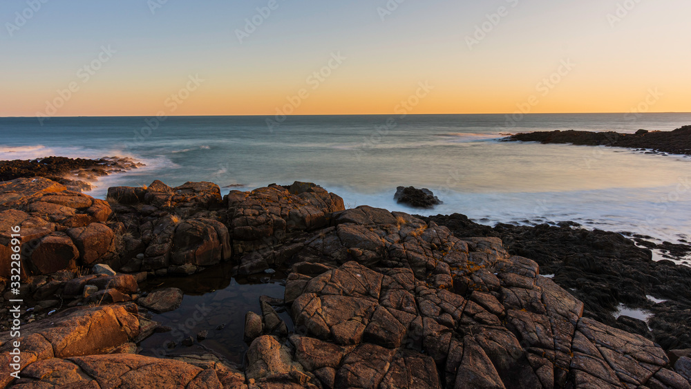 Sunset long exposure of rocks and ocean Sunset long exposure of rocks and ocean