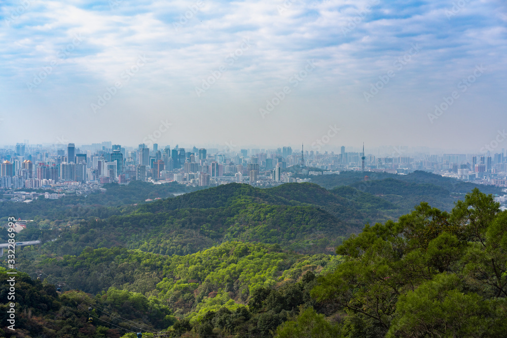 Taking photos of Guangzhou downtown at the top of Baiyun Mountain