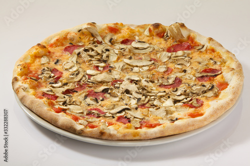 Flatlay of Italian pizza on white background. Rustic homemade pizzas with salami, bacon, cheese, eggs and raw vegetables on shabby wooden background. Healthy vegetarian fungi pizza