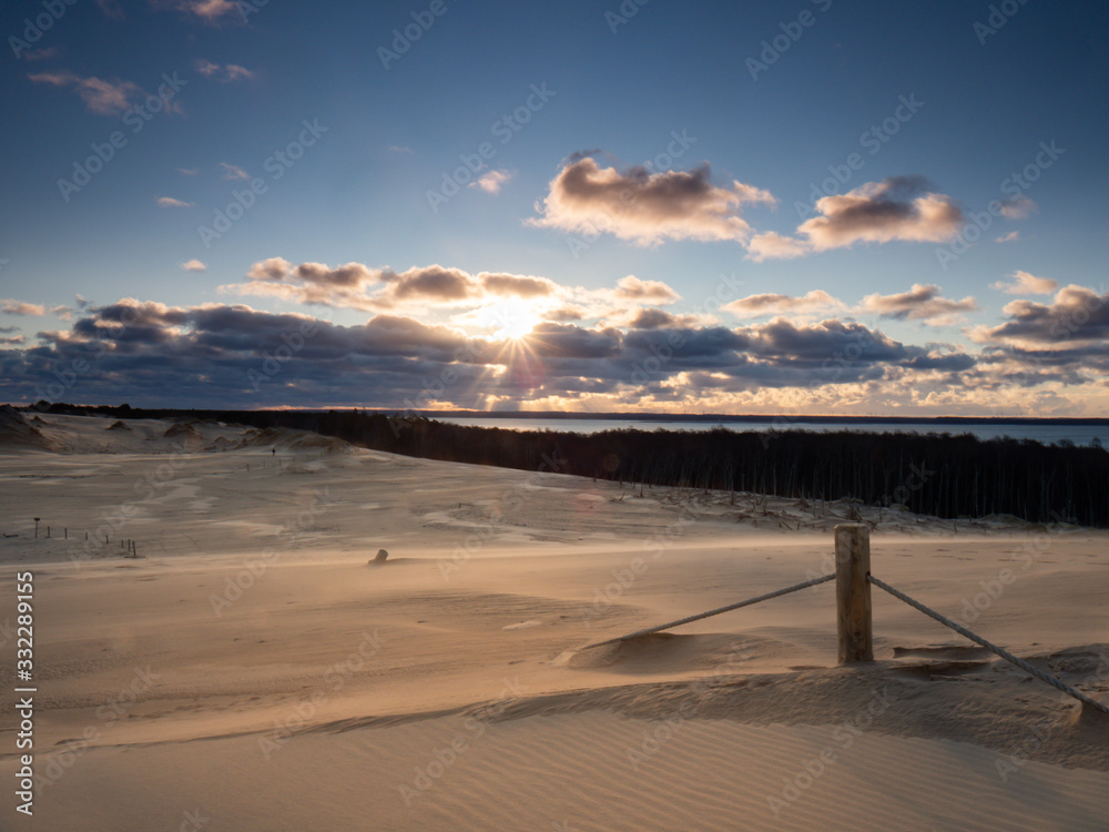 Sunrise on the moving dunes during windy morning. Sunrise on the moving dunes during windy morning.