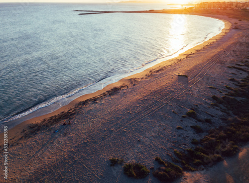 Aerial views of a girl with her dog at a virgin beach, in Natural park Punta Entinas, Almeria, Spain photo