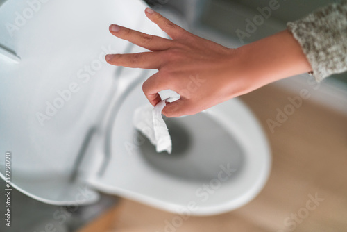 Fototapeta Flushing down disinfectant wipes as toilet paper shortage alternative during panic buying coronavirus outbreark causing home toilets to clog