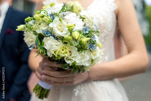 Beautiful wedding bouquet in the hand of the bride close-up
