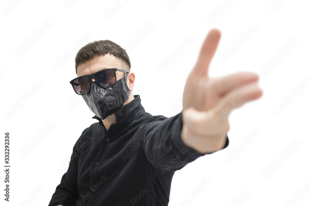 brunette man in sunglasses in a black shirt and a black mask on his face on a white background