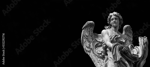 Photography Angel statue holding the garment and dice of Jesus Passion
