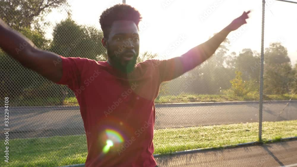African American man working out by doing jumping jacks