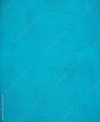 Close up on stucco wall painted turquoise