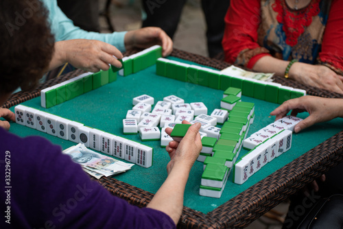 people playing mahjong in a tea garden in china