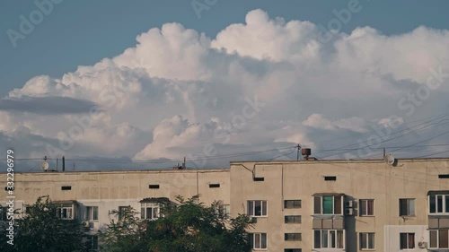 Amazing volumetric clouds over an multi-story building photo