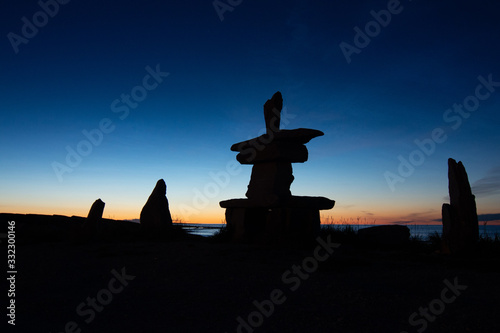 iconic churchill manitoba inukshuk after sunset with the glow of twilight