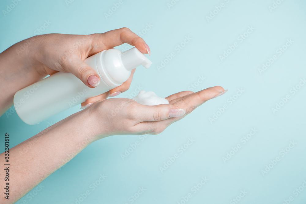 Woman uses liquid antibacterial soap to disinfect her hands. Coronavirus prevention, health protection concept. Woman uses liquid antibacterial soap to disinfect her hands. Coronavirus prevention, health protection concept.