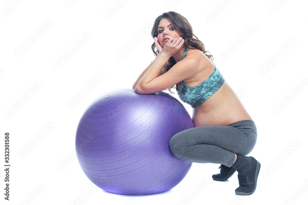 Portrait of a beautiful young pregnant woman exercises with fitball. Working out and fitness, pregnancy concept. Isolated white background. Portrait of a beautiful young pregnant woman exercises with fitball. Working out and fitness, pregnancy concept. Isolated white background.