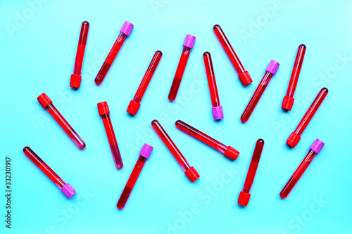 Blood in test tubes on blue background.