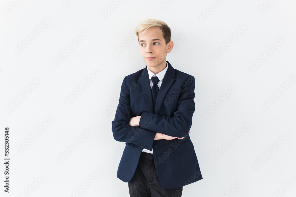 Portrait of stylish school boy teenager in white shirt and jacket against white background with copy space. Portrait of stylish school boy teenager in white shirt and jacket against white background with copy space.