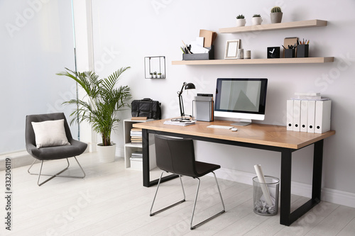 Modern computer on table in office interior. Stylish workplace photo