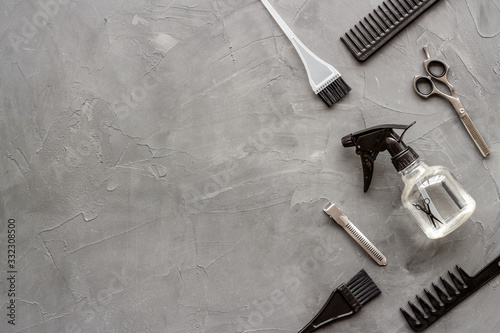 Beauty saloon concept. Hairdresser accessories pattern on grey stone background top-down frame copy space
