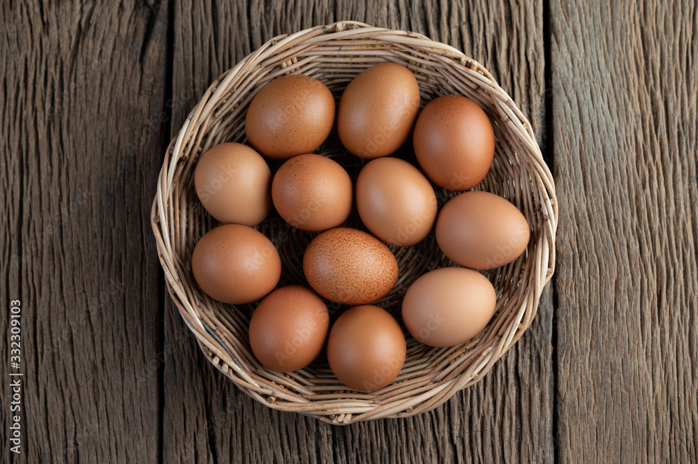 Lay eggs in a wooden basket on a wooden floor. Lay eggs in a wooden basket on a wooden floor.