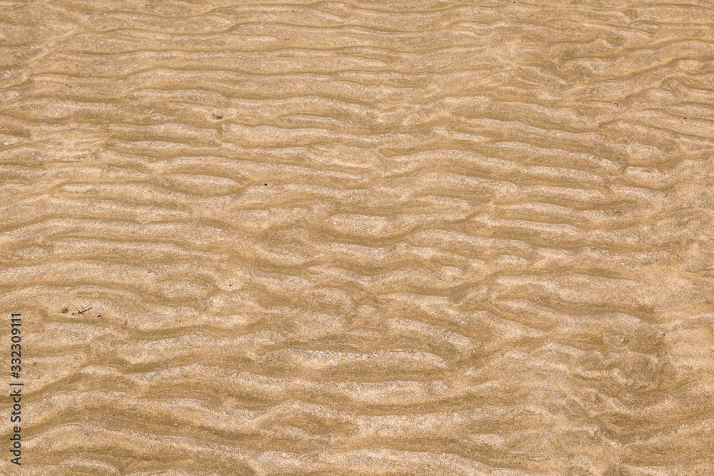 Yellow wave sand texture on the beach Yellow wave sand texture on the beach