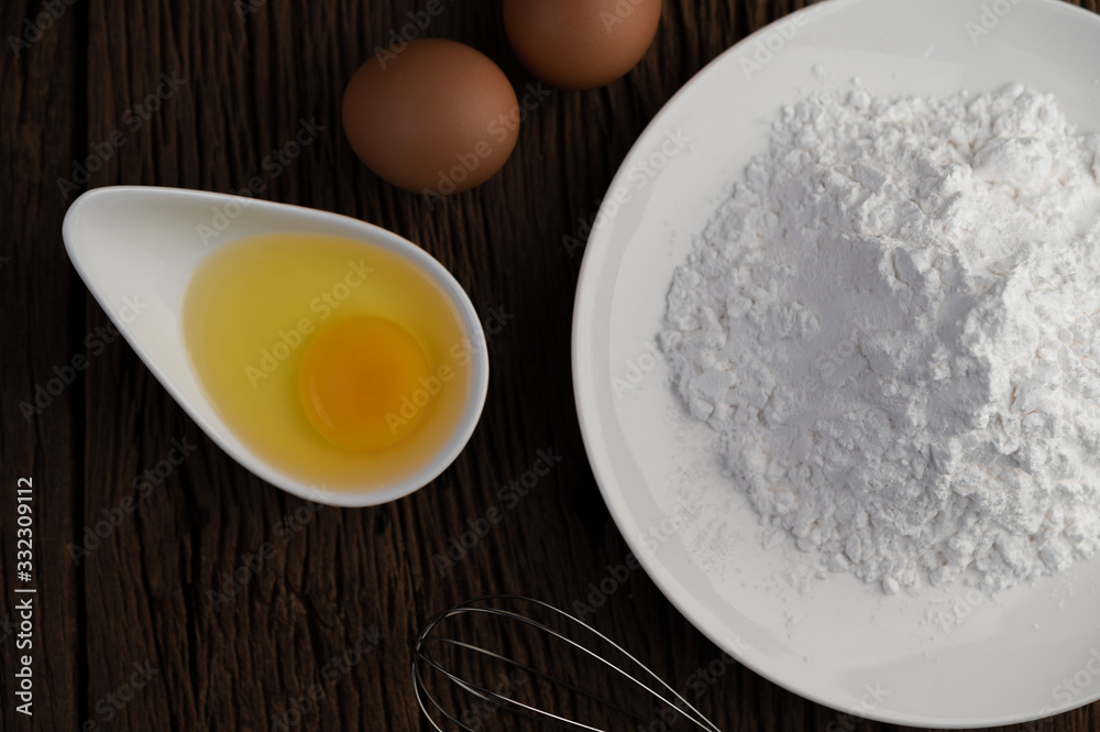 Eggs, tapioca flour and an egg beater, ingredients used in bakery Eggs, tapioca flour and an egg beater, ingredients used in bakery