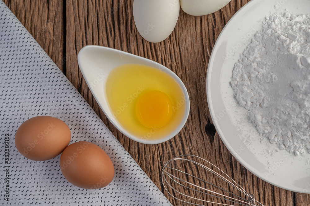 Eggs, tapioca flour and an egg beater, ingredients used in bakery Eggs, tapioca flour and an egg beater, ingredients used in bakery