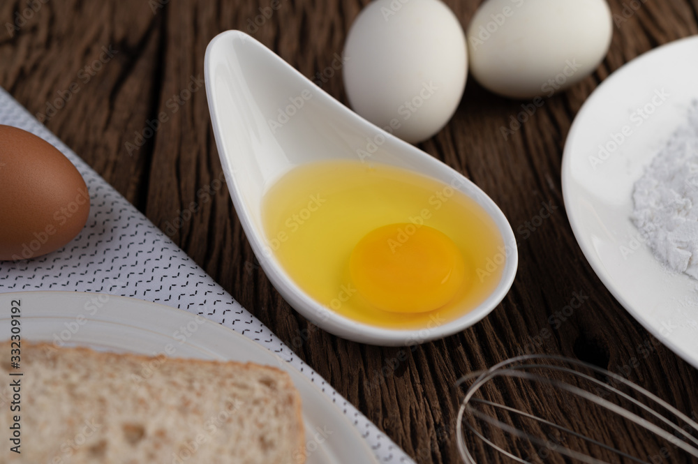 Eggs, bread, tapioca flour and an egg beater, ingredients used in bakery Eggs, bread, tapioca flour and an egg beater, ingredients used in bakery
