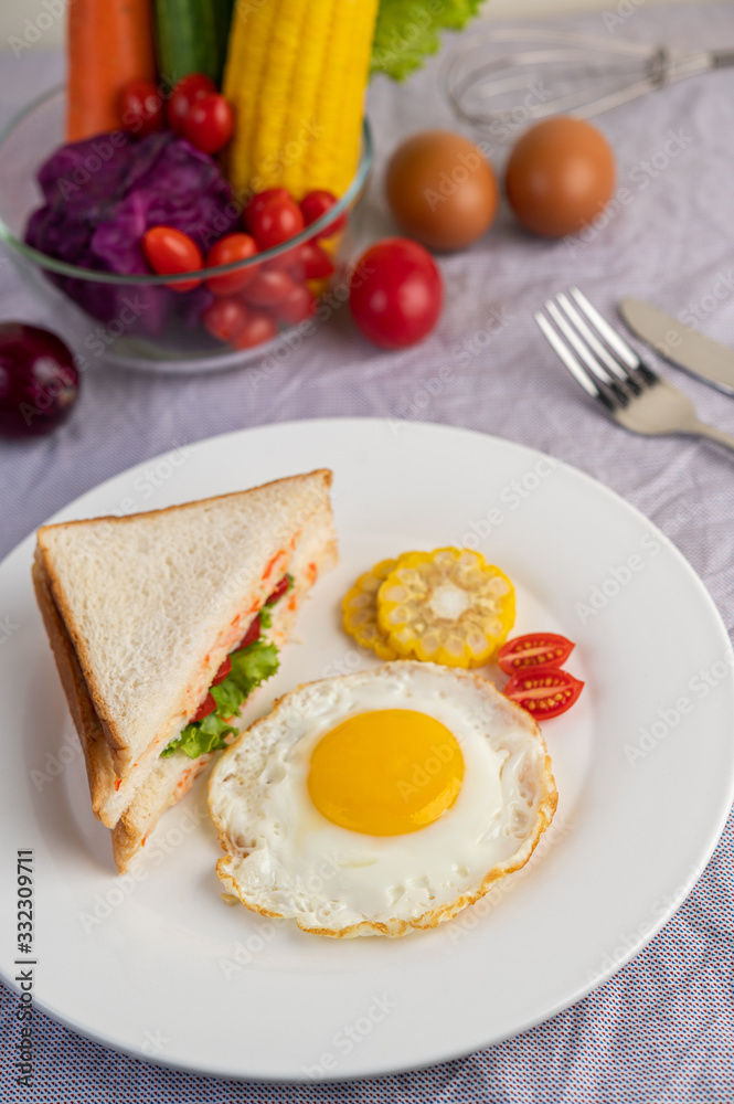 American breakfast on a white background with fried egg, salad, pumpkin, cucumber, carrot, corn, cauliflower, tomato and sandwich American breakfast on a white background with fried egg, salad, pumpkin, cucumber, carrot, corn, cauliflower, tomato and sandwich
