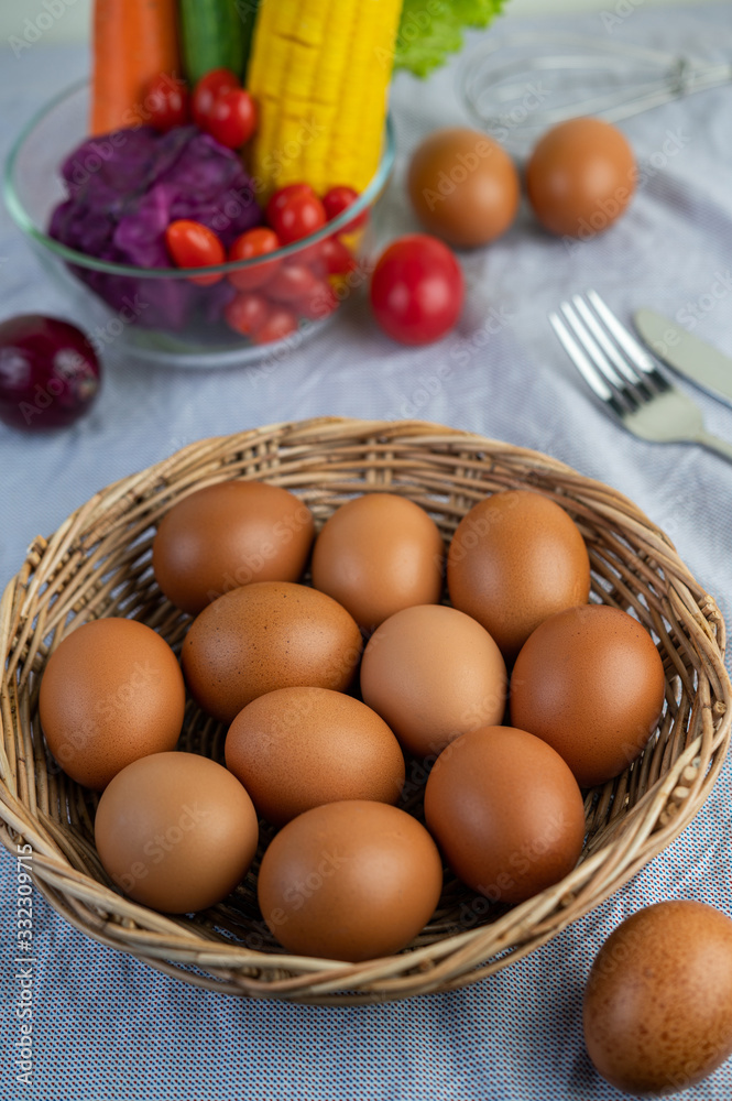 Lay eggs in a wooden basket on a wooden floor. Lay eggs in a wooden basket on a wooden floor.