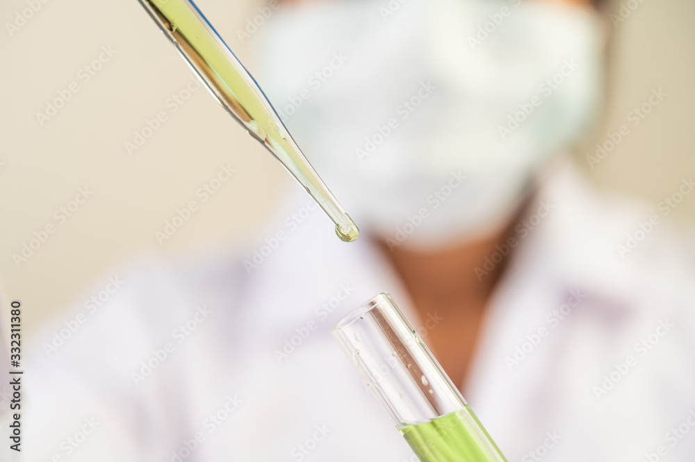 Scientists wear masks and gloves, carrying beakers with vaccines. Scientists wear masks and gloves, carrying beakers with vaccines.