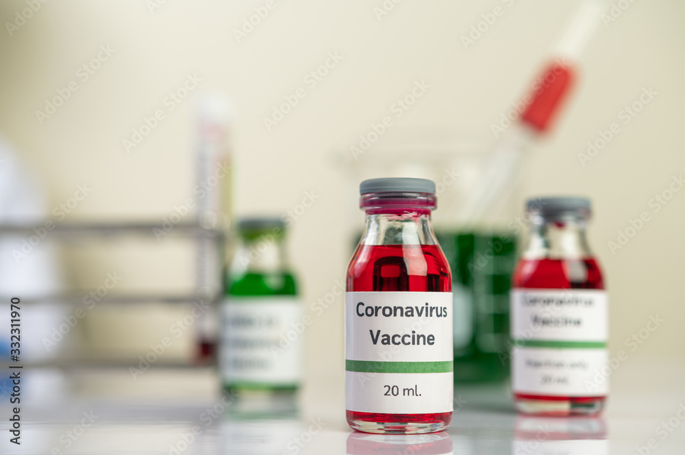 The vaccine against the covid-19 is in red and green in bottles placed on the floor.