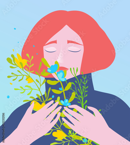 Lady holding a bouquet of wild flowers eyes closed dreaming of summer or spring.