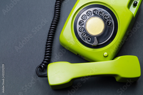 Classic phone with handset. vintage green telephone with phone receiver. office background. old communication technology