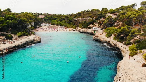 Drone flyover Calo des Moro beach Mallorca island, Spain, dolly forward photo