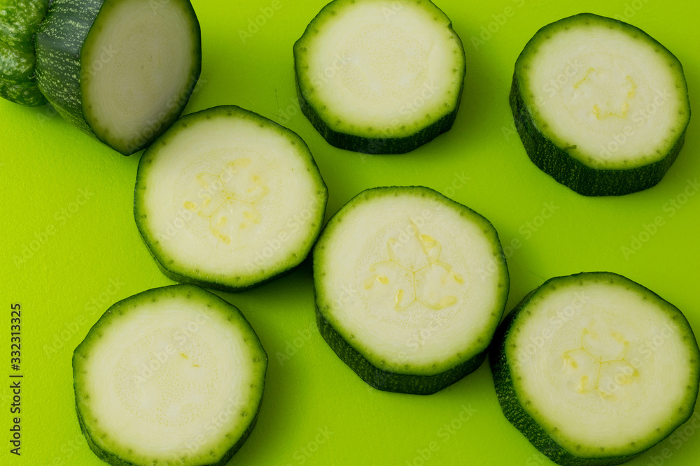 fresh green zucchini slices on green fresh green zucchini slices on green