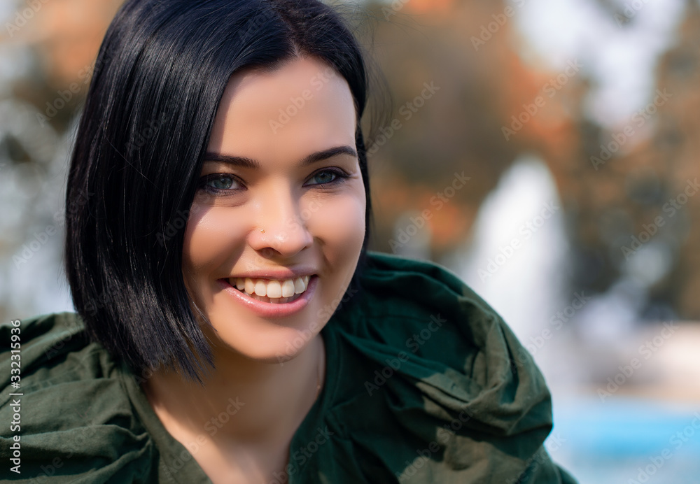 Attractive woman with short hair being very glad smiling with broad smile showing her perfect teeth having fun outdoors. Joyful excited female rejoicing after being proposed to marry. Attractive woman with short hair being very glad smiling with broad smile showing her perfect teeth having fun outdoors. Joyful excited female rejoicing after being proposed to marry.