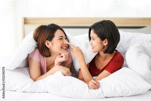 Asian Couple lesbian LGBT on bed in bedroom, Love happiness moment concept.