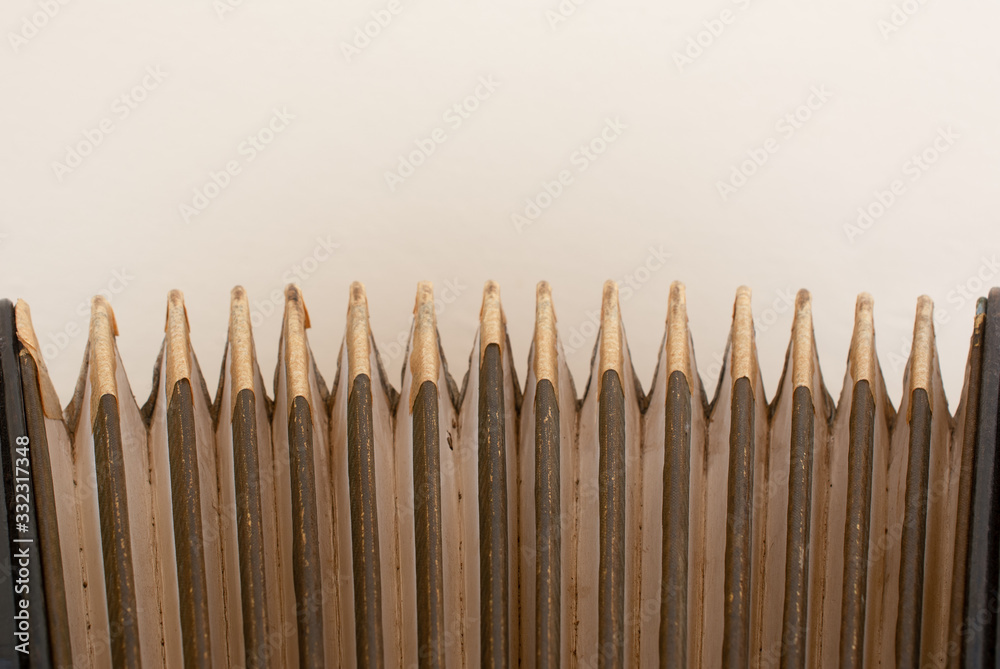 detail of old accordion bellows on wooden table in vintage tone, close up. music concept detail of old accordion bellows on wooden table in vintage tone, close up. music concept