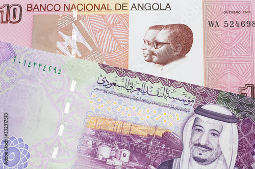 Wallpaper Mural A colorful ten kwanza bill from Angola with a colorful, Saudi Arabian riyal bank note close up in macro Torontodigital.ca