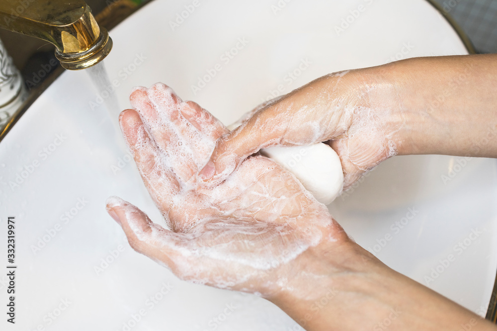Unrecognizable person washing hands, rubbing with soap in sink under water. Hand disinfection. Close up photo. Coronavirus, covid-19, 2019 pandemic prevention. disinfect, sanitize, epidemic concept . Unrecognizable person washing hands, rubbing with soap in sink under water. Hand disinfection. Close up photo. Coronavirus, covid-19, 2019 pandemic prevention. disinfect, sanitize, epidemic concept .